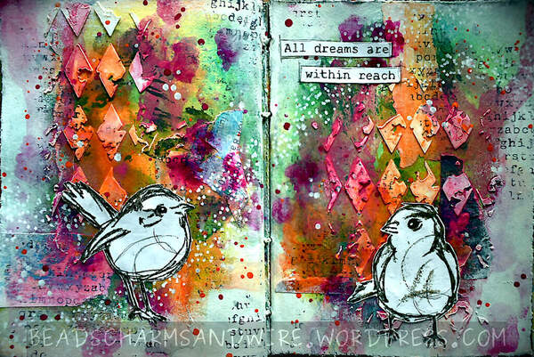Art journal spread with vivid colors, stenciled textures, stamped areas, and marks in the background; and black-and-white stamped birds as focal elements